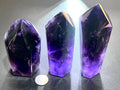 Large dark purple faceted amethyst crystal tower
