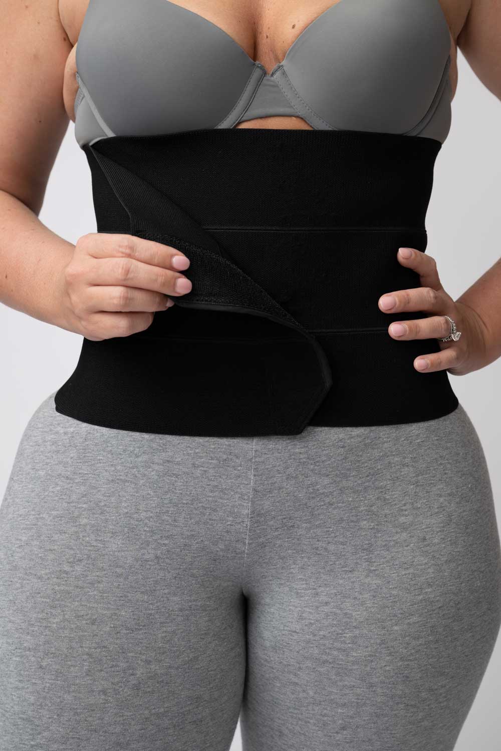 Black 3-panel post-op abdominal binder with hook-and-loop closure, view 2