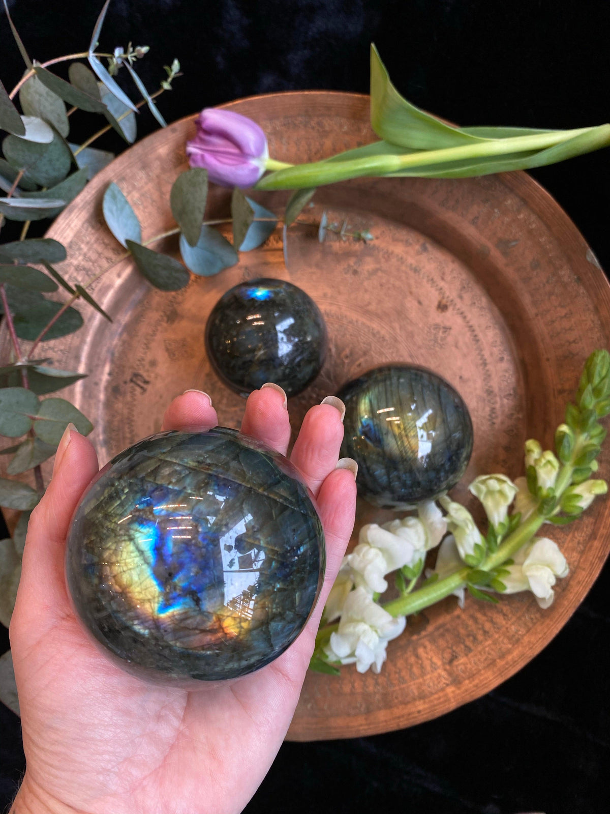Polished labradorite crystal sphere with blue flash