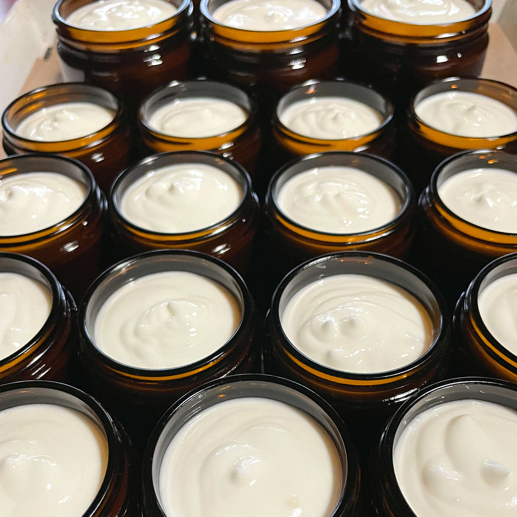 Open jars of magnesium skin cream showing the texture
